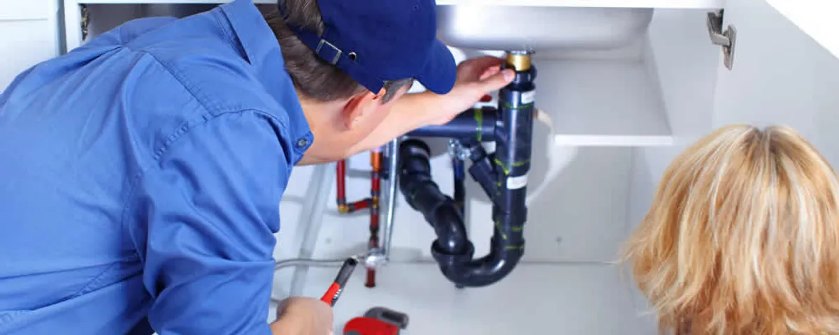 Plumber repairing under-sink drain pipes and fittings in Royal Oak, MI